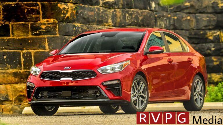2021 Kia Forte in red parked next to a brick wall.