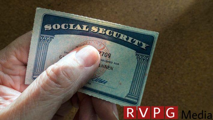 A senior citizen holds their Social Security.