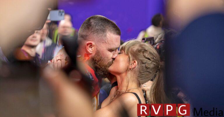 Travis Kelce packs on the PDA with Taylor Swift at charity auction