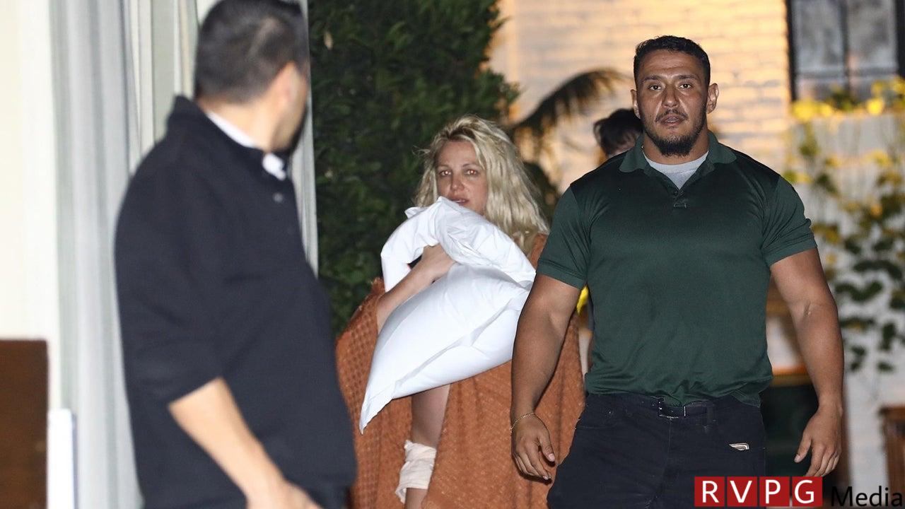 Britney Spears leaves with friends after an ambulance is called to the hotel