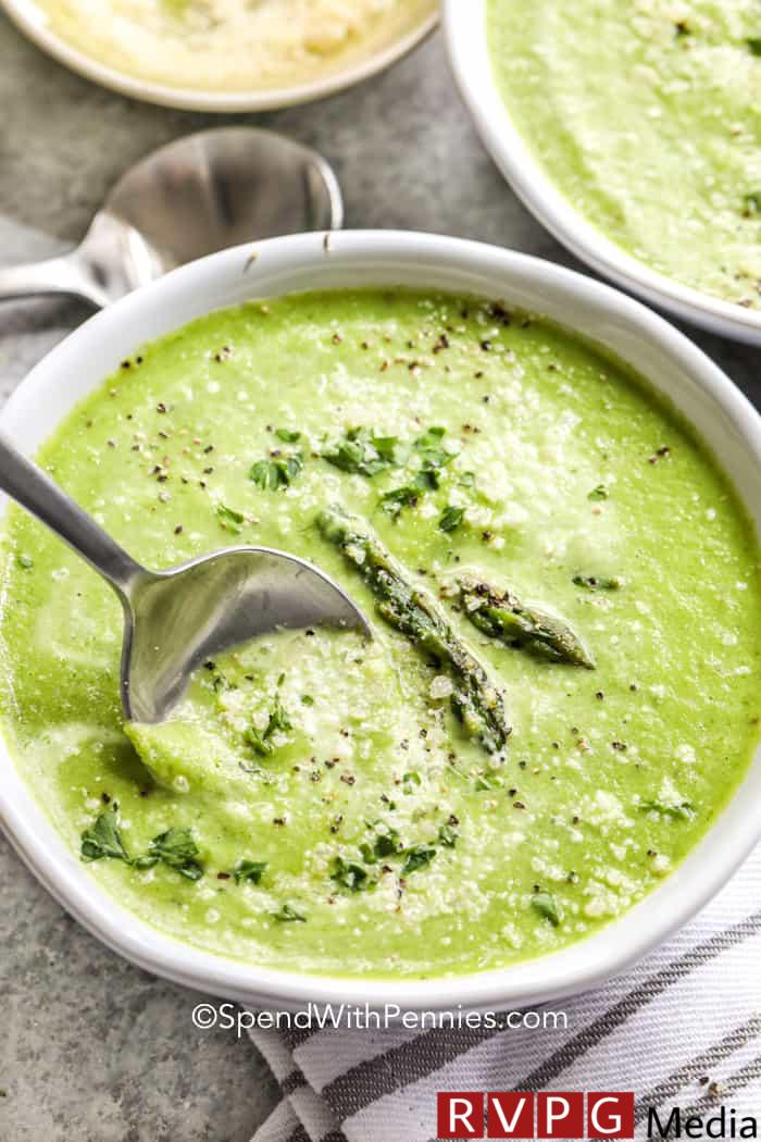 Asparagus Soup in a white bowl with a spoon
