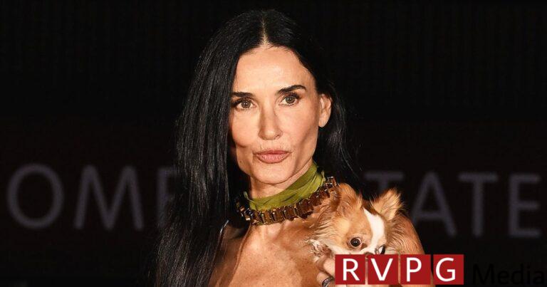 Demi Moore Wears Lace Dress and Dog Pilaf at Gucci Show