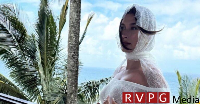 Hailey Bieber cradles her baby bump in a new photo from the maternity shoot