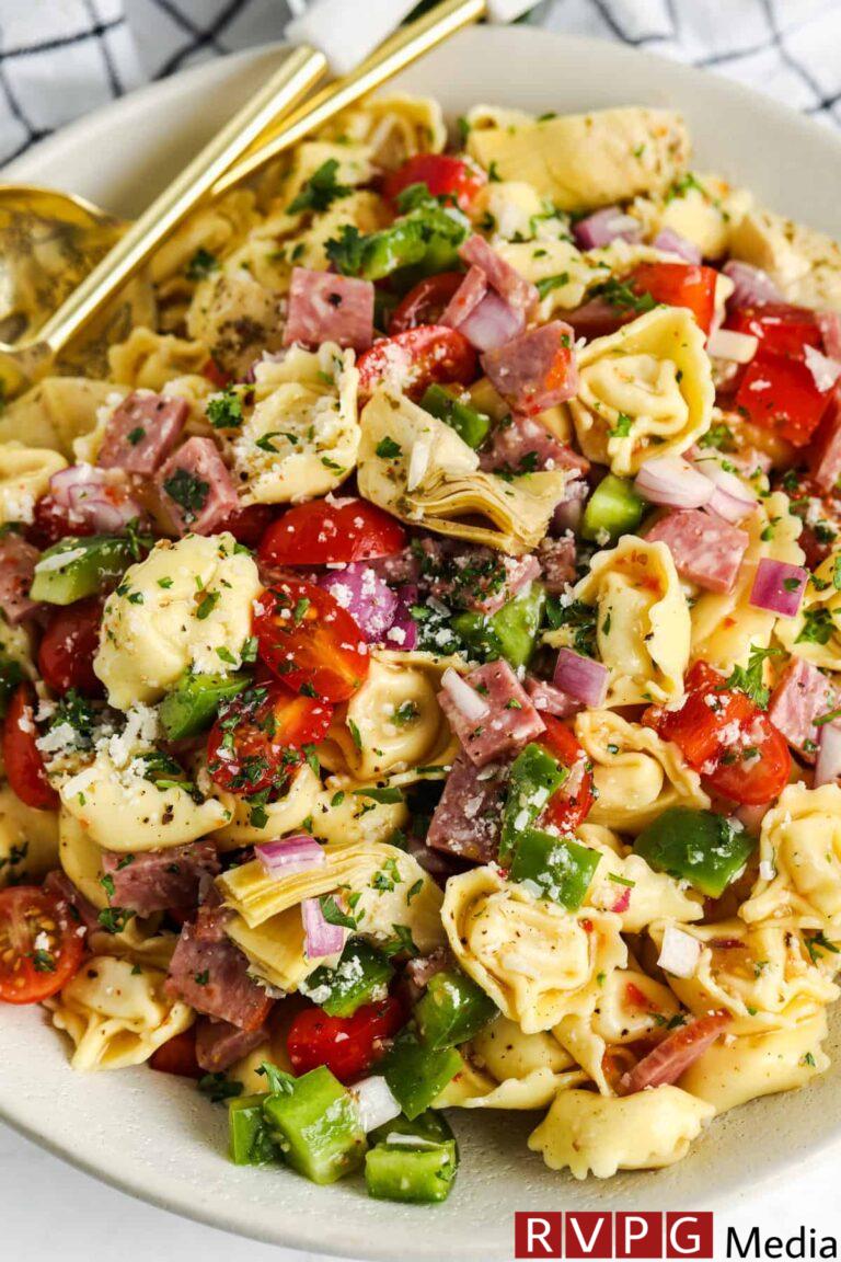 close up of Italian Tortellini Salad on a plate with a spoon and fork