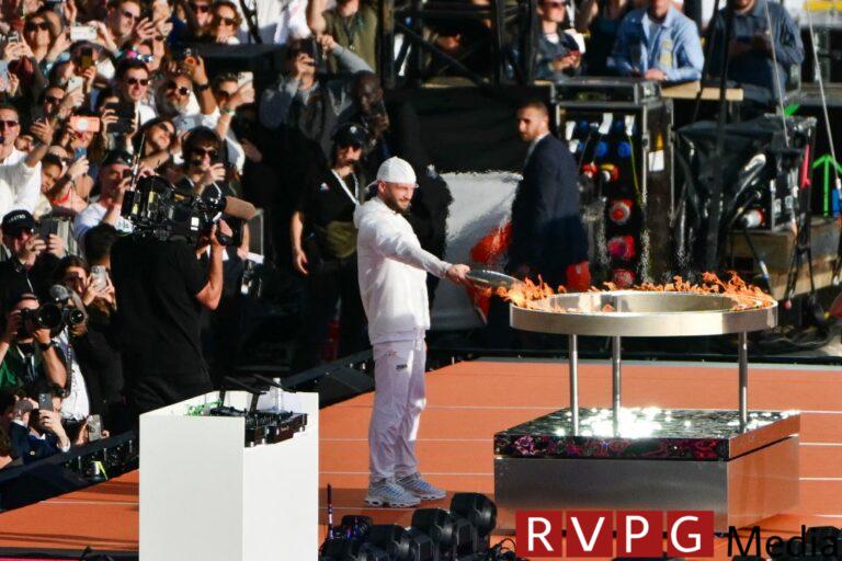 The Olympic flame reaches France under strict security precautions in the test run for the opening ceremony in Paris