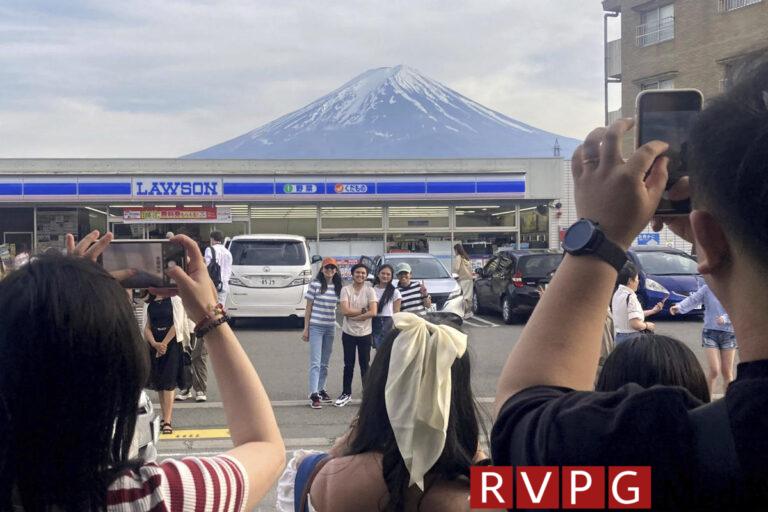 To ward off tourists, a city in Japan is building a large screen that blocks the view of Mount Fuji