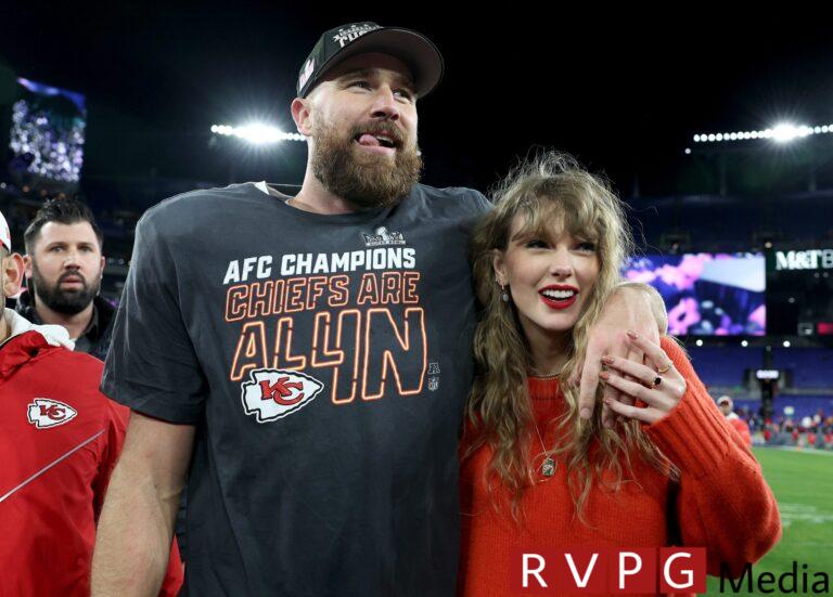 Travis Kelce of the Kansas City Chiefs celebrates with Taylor Swift after a 17-10 victory against the Baltimore Ravens in the AFC Championship Game at M&T Bank Stadium on January 28, 2024 in Baltimore, Maryland.
